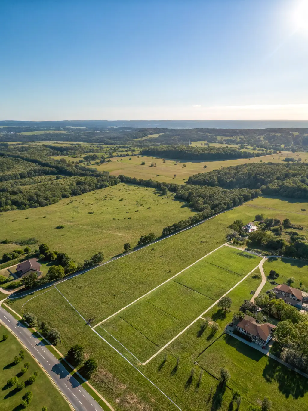 A sprawling plot of land with preliminary development plans visible, illustrating a land development investment opportunity. The image should convey the potential for future growth and construction.